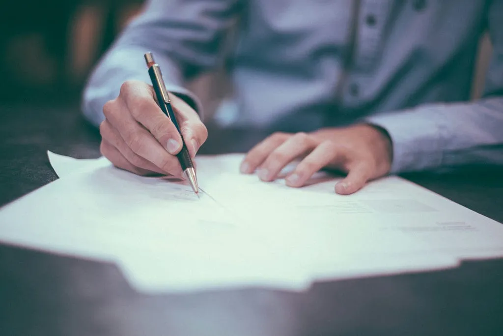 A desk with a notebook and pen